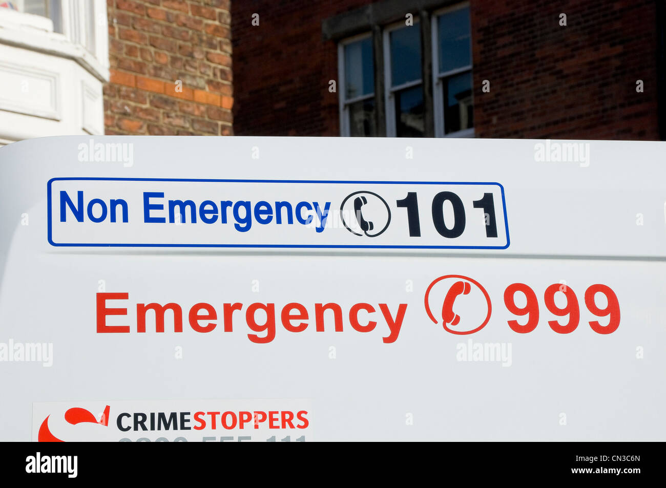 Close up of telephone phone numbers on police van England UK United