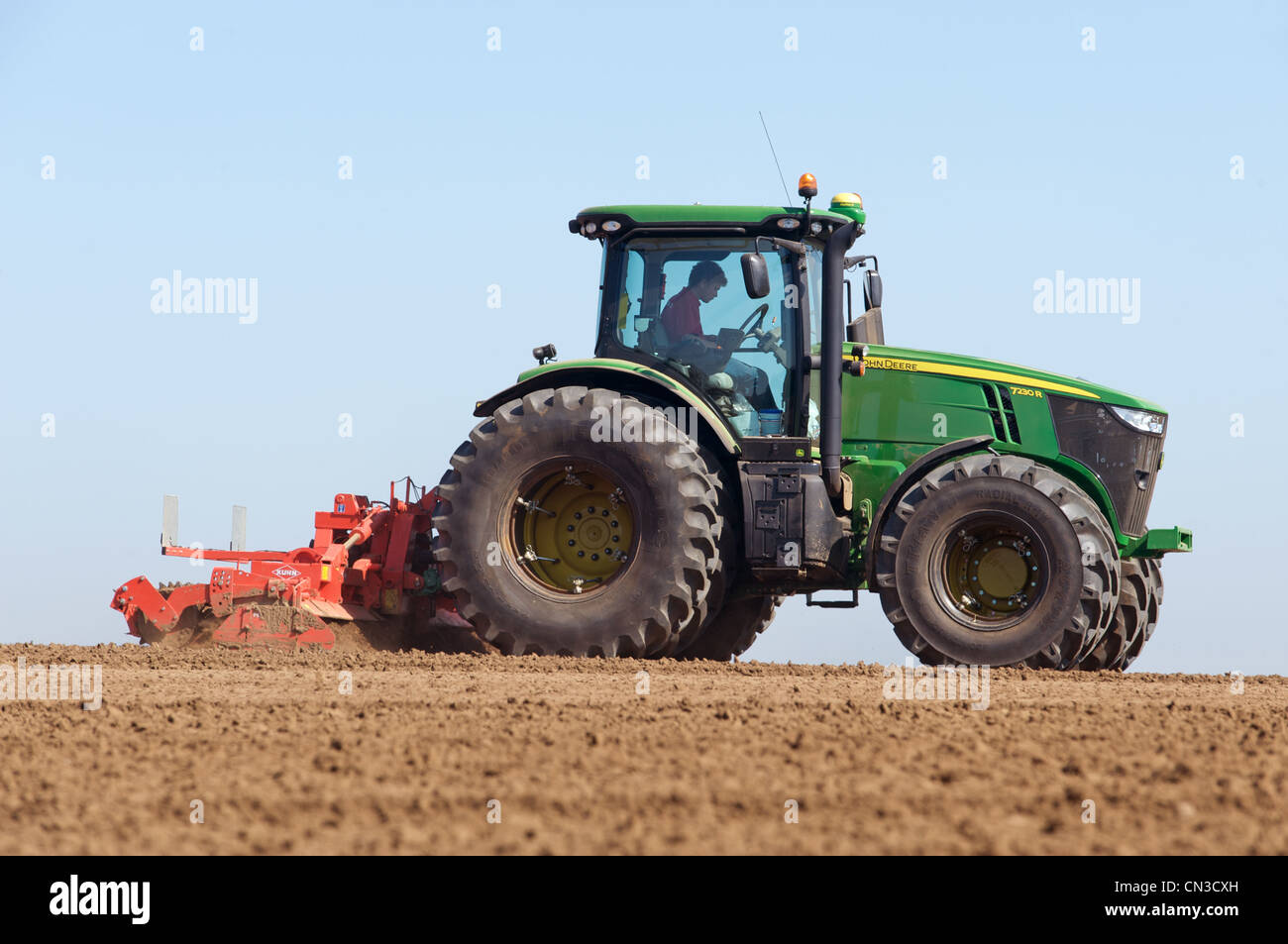John Deere 7230R tractor fitted with Kuhn cultivator Stock Photo