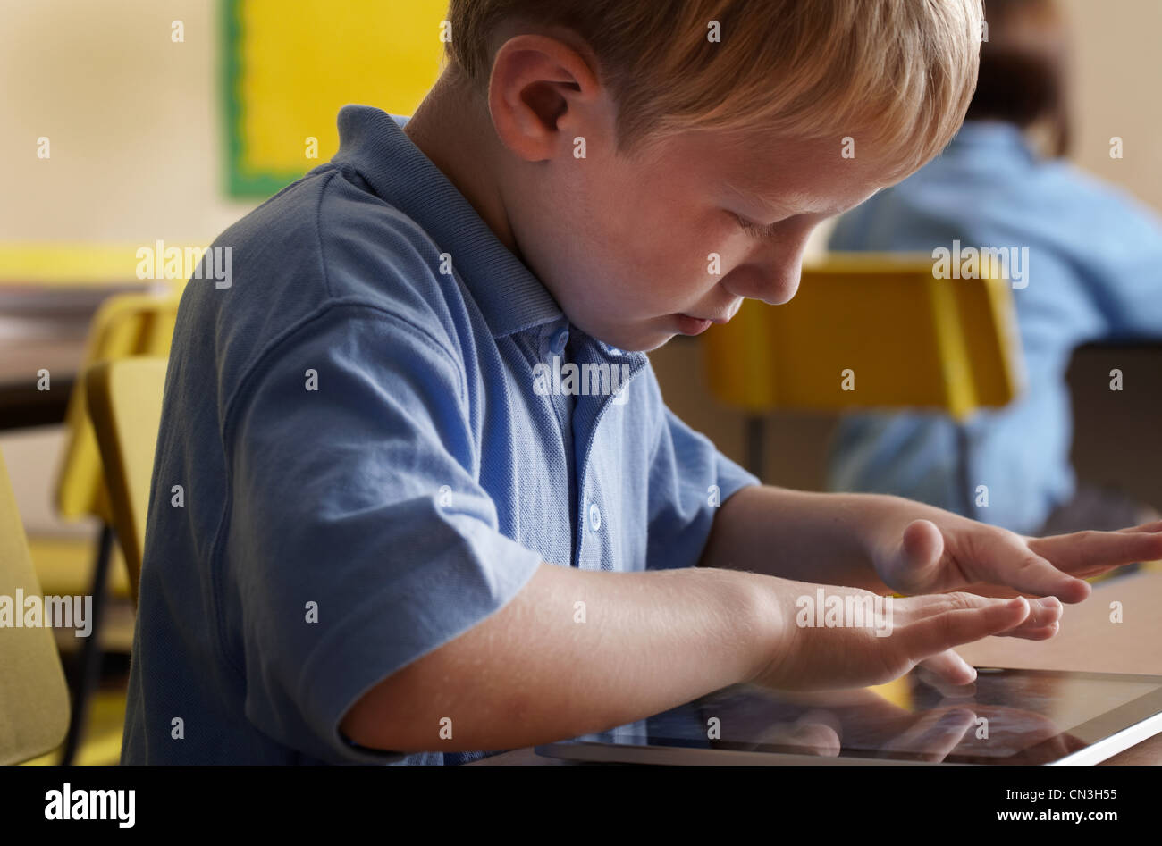 Student Using Touch Screen School boy using touch screen notebook in classroom Stock Photo - Alamy