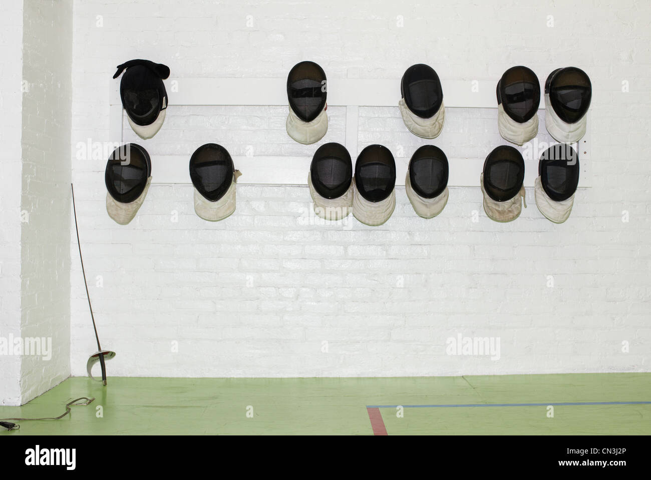 Fencing masks hanging from wall Stock Photo Alamy