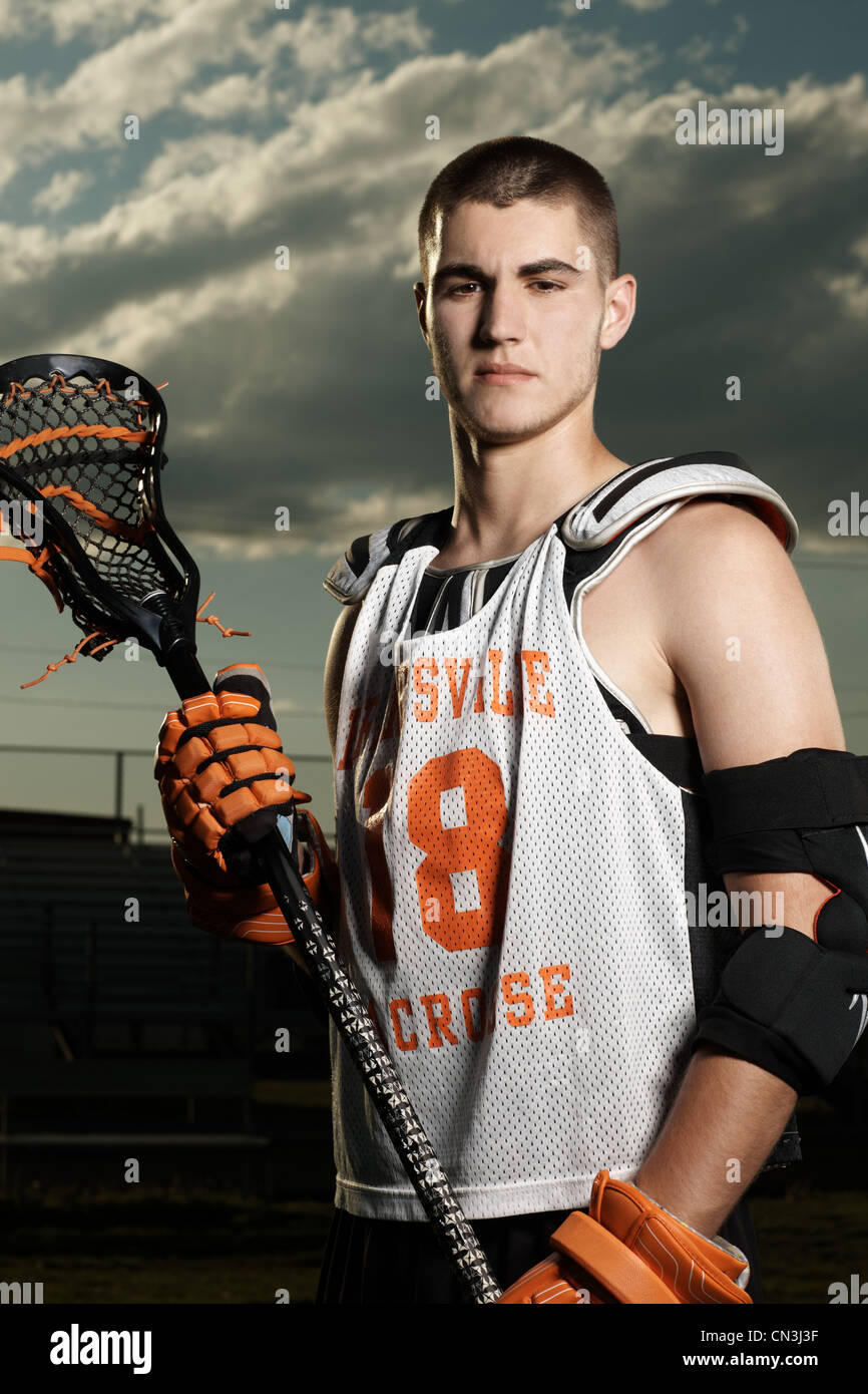 Portrait of young sportsman holding lacrosse stick Stock Photo Alamy