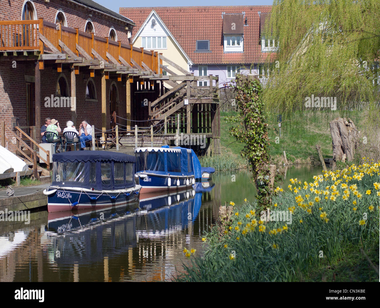 People drinking outside The Grannary, Suffolk Riverside Trust, in Sudbury, Suffolk, England. Stock Photo