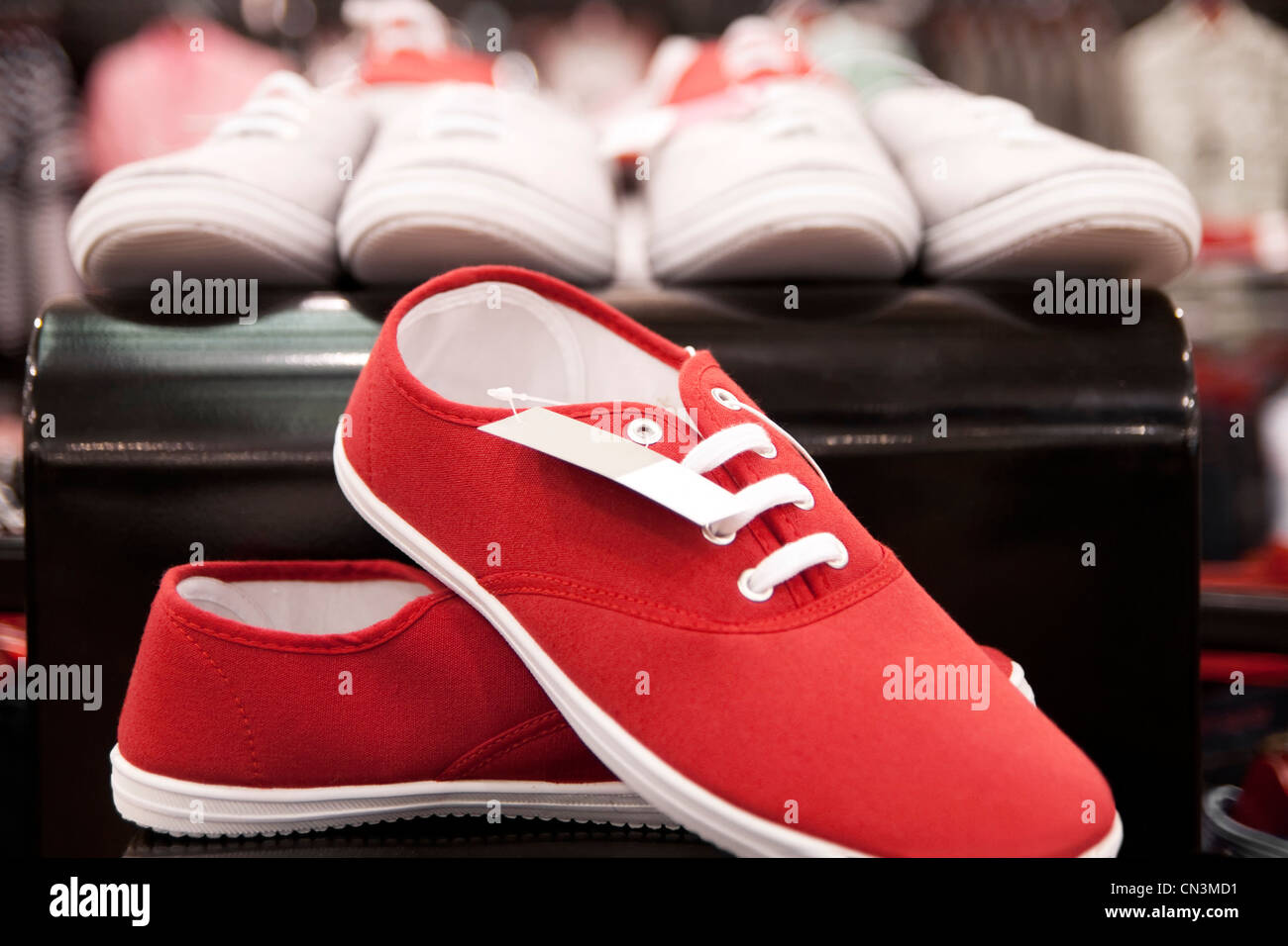 Red sneakers exposed on the shelf. Stock Photo
