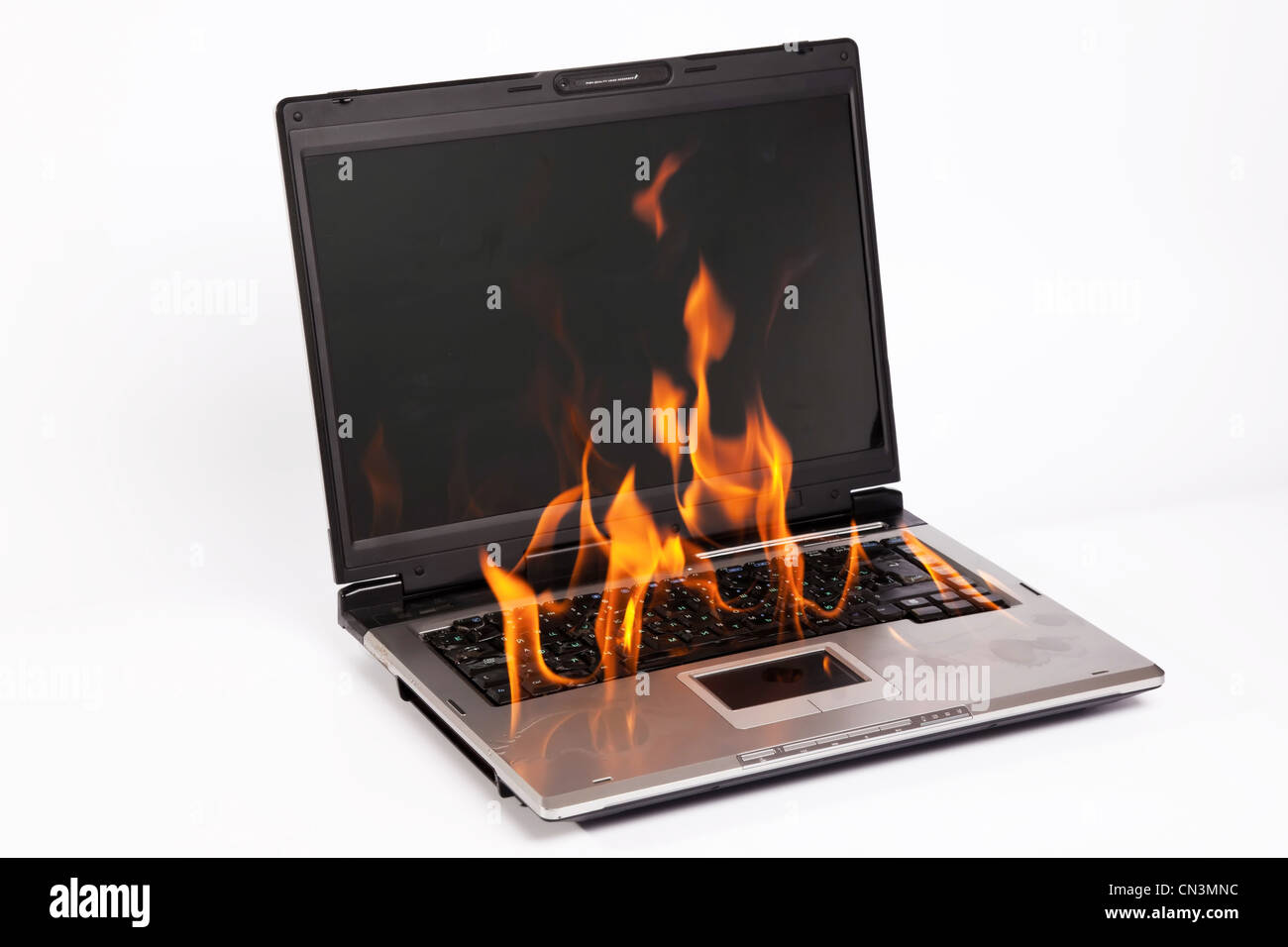 Laptop burning with fire on white background Stock Photo - Alamy