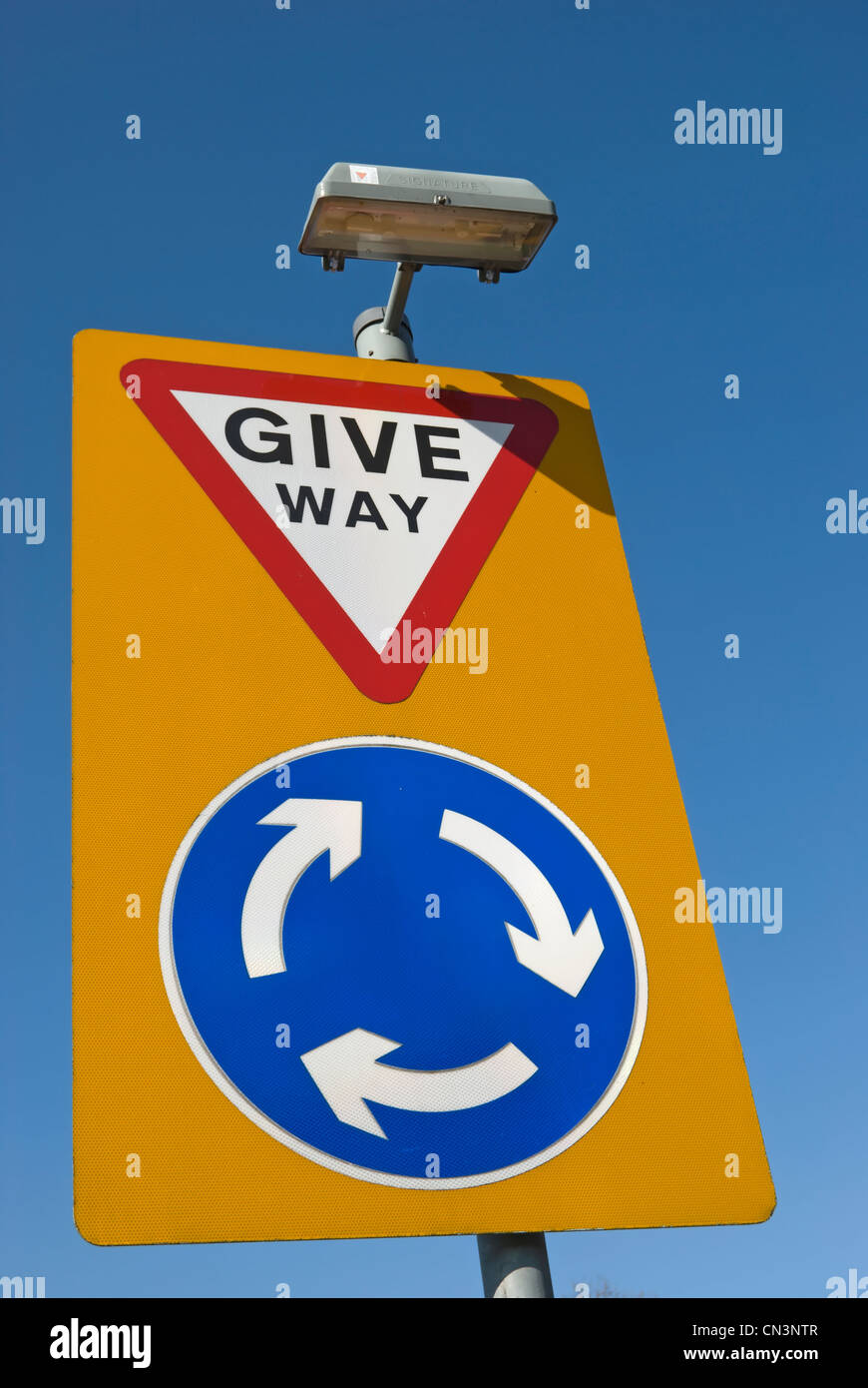 british road sign indicating a roundabout where approaching drivers
