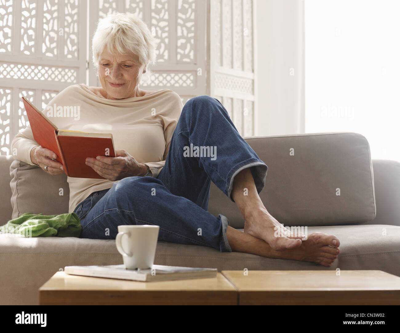 Old woman sitting alone sofa hi-res stock photography and images - Alamy
