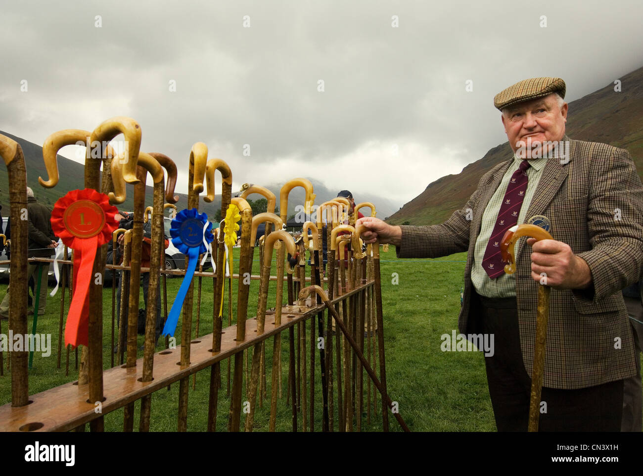 Man holding a walking stick after prize giving Stock Photo