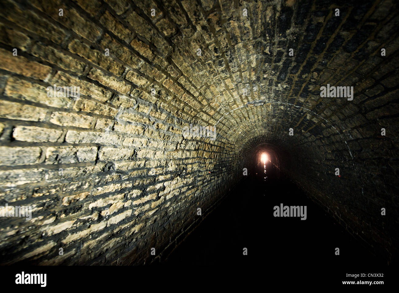 A light shining at the end of a tunnel Stock Photo