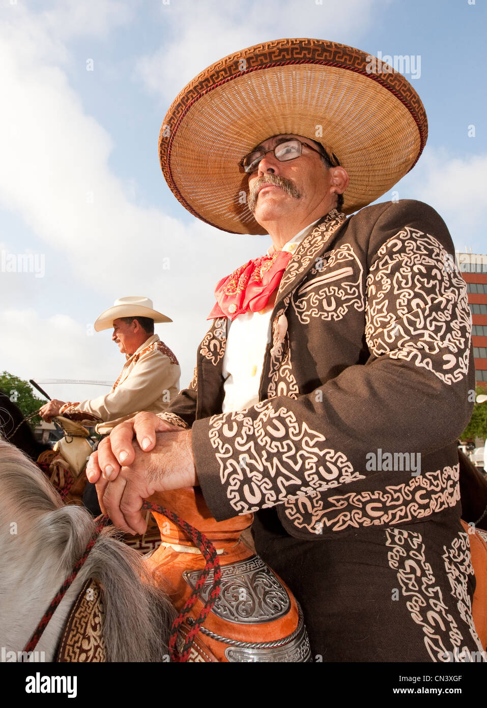 Male dressed up as a Charro, traditional horseman from Mexico rides horse during parade in Austin, Texas Stock Photo