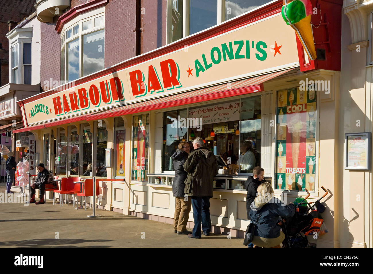 People tourists visitors at Harbour Bar cafe kiosk selling icecream and snacks in winter Scarborough North Yorkshire England UK United Kingdom Britain Stock Photo