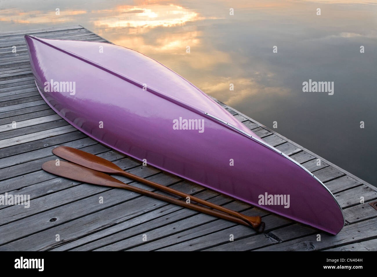 Pink canoe and paddles on dock, Algonquin Park, Ontario Stock Photo