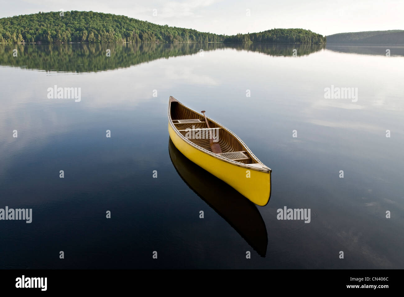 Yellow canoe floating on Smoke Lake, Algonquin Park, Ontario Stock Photo