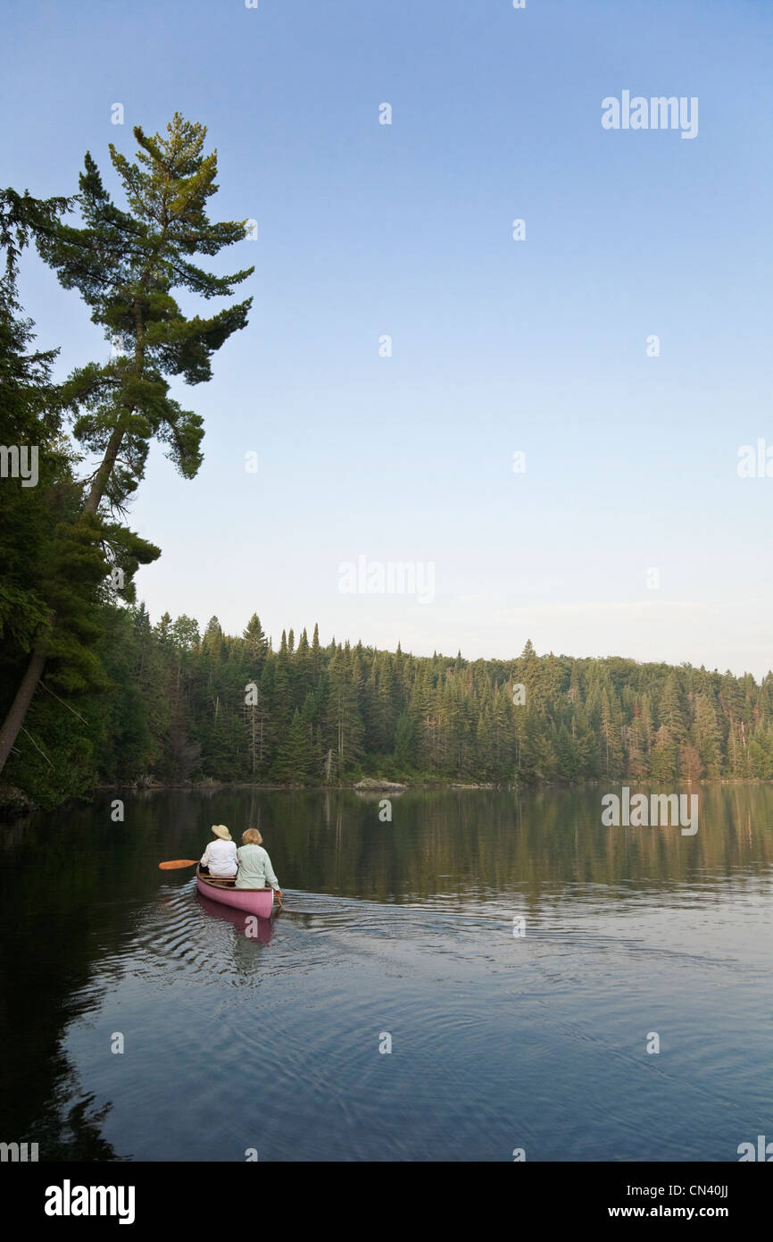 Canoeists paddling, Smoke lake, Algonquin Park, Ontario Stock Photo