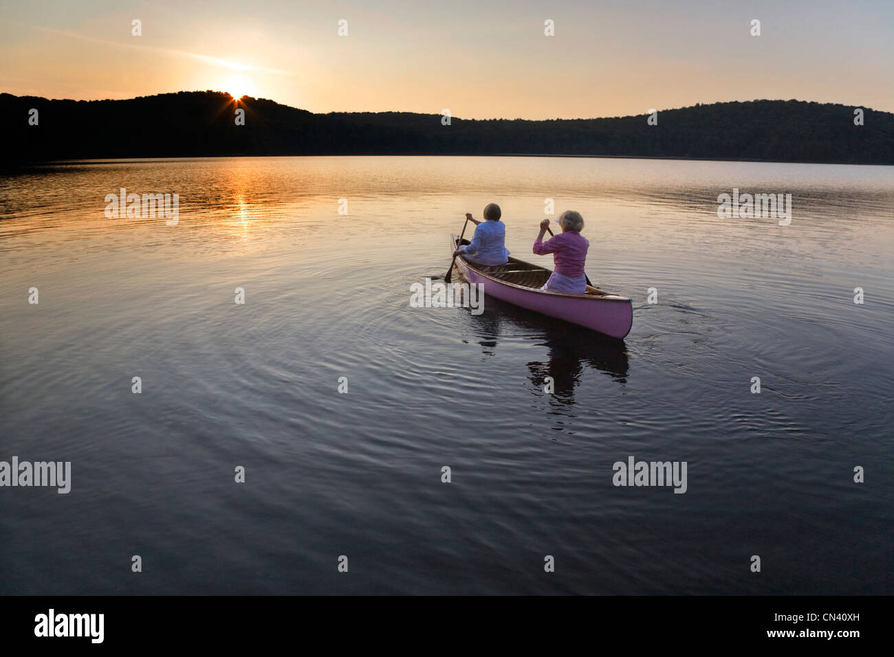 Paddling toward the sunset, Smoke Lake, Algonquin Park, Ontario Stock Photo