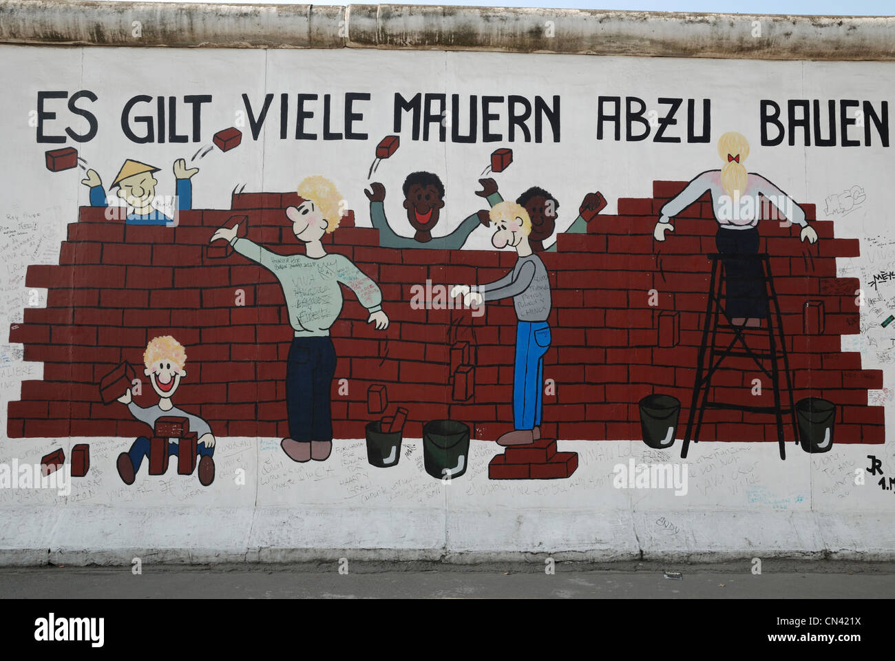 "Es gilt viele Mauern abzubauen" by Ines Bayer and Raik Hönemann on the Berlin Wall at the East Side Gallery, Berlin, Germany. Stock Photo