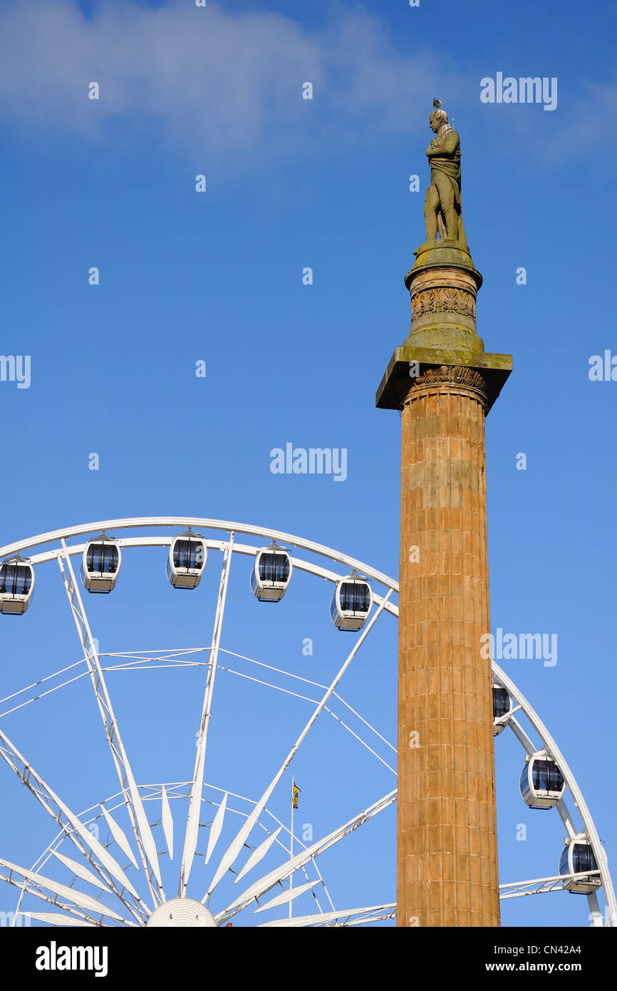 The centre column in George Square supports the figure of Sir Walter Scott and the big wheel is viewed to the rear. Stock Photo