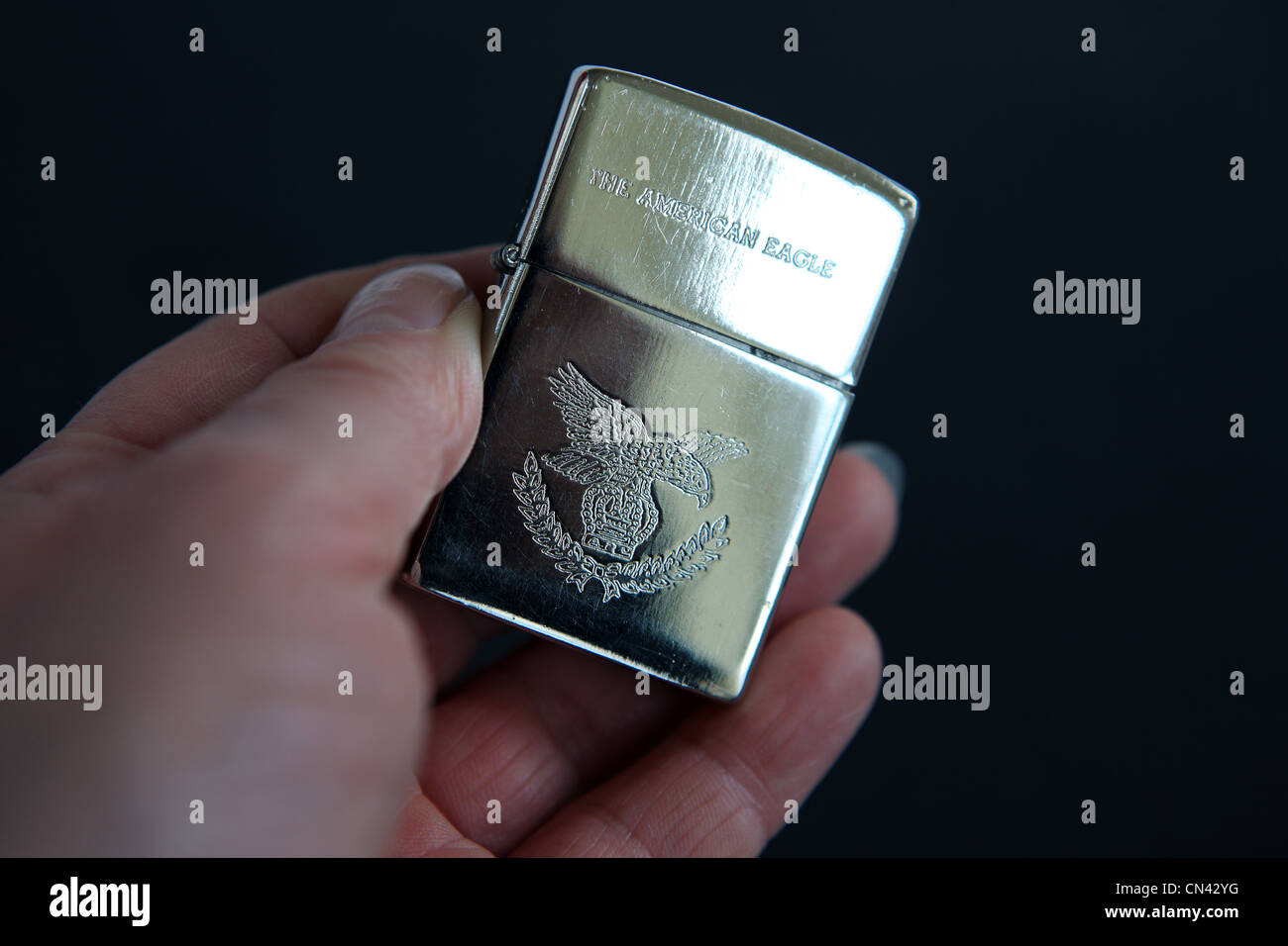 Hand holding a Zippo American Eagle lighter Stock Photo Alamy