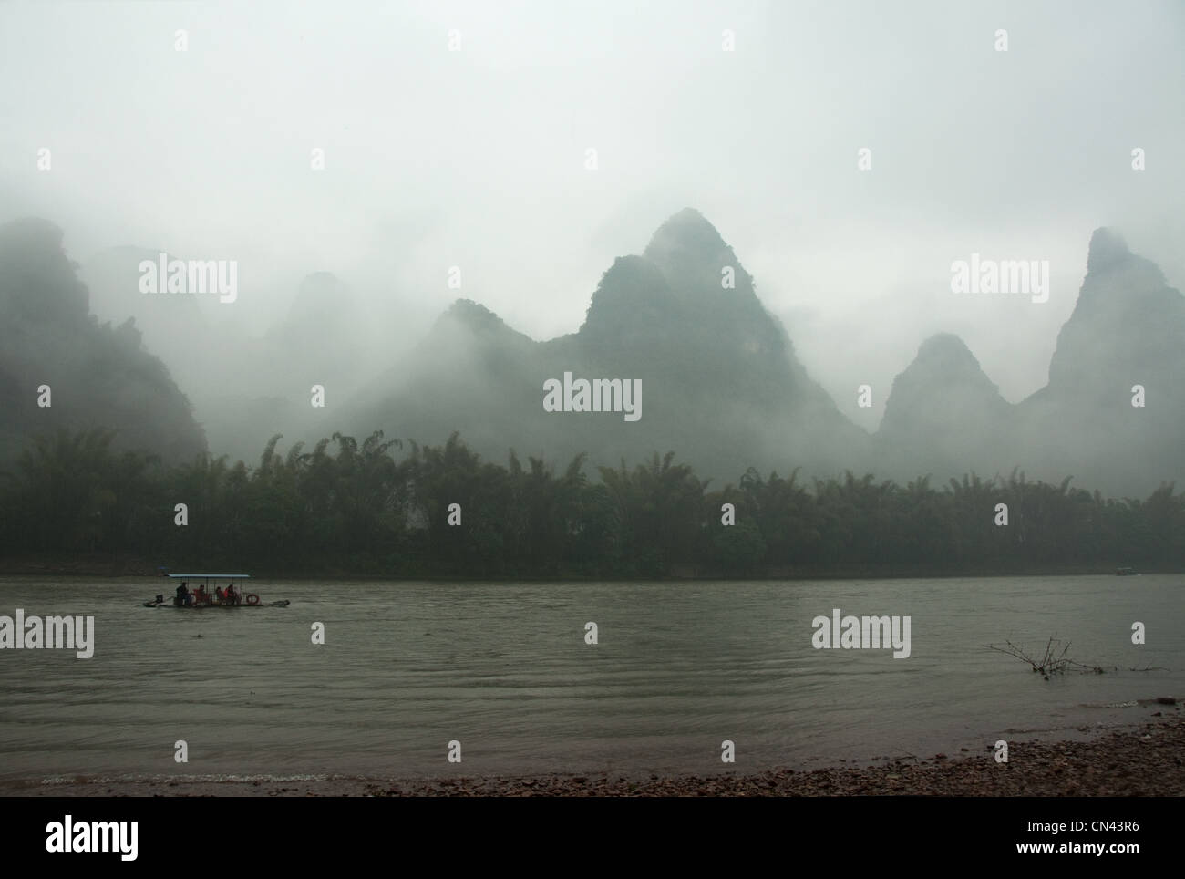 raft on Li River on a foggy day, Yangshuo, Guilin, Guangxi Province, Southern China Stock Photo