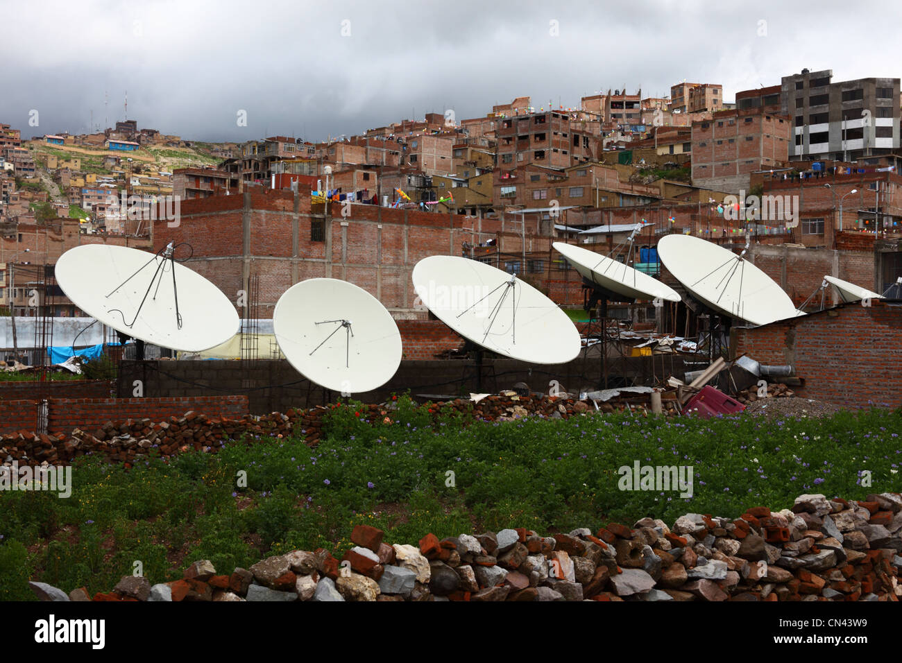 Satellite dishes and brick houses on hillside suburbs , Puno , Peru Stock Photo
