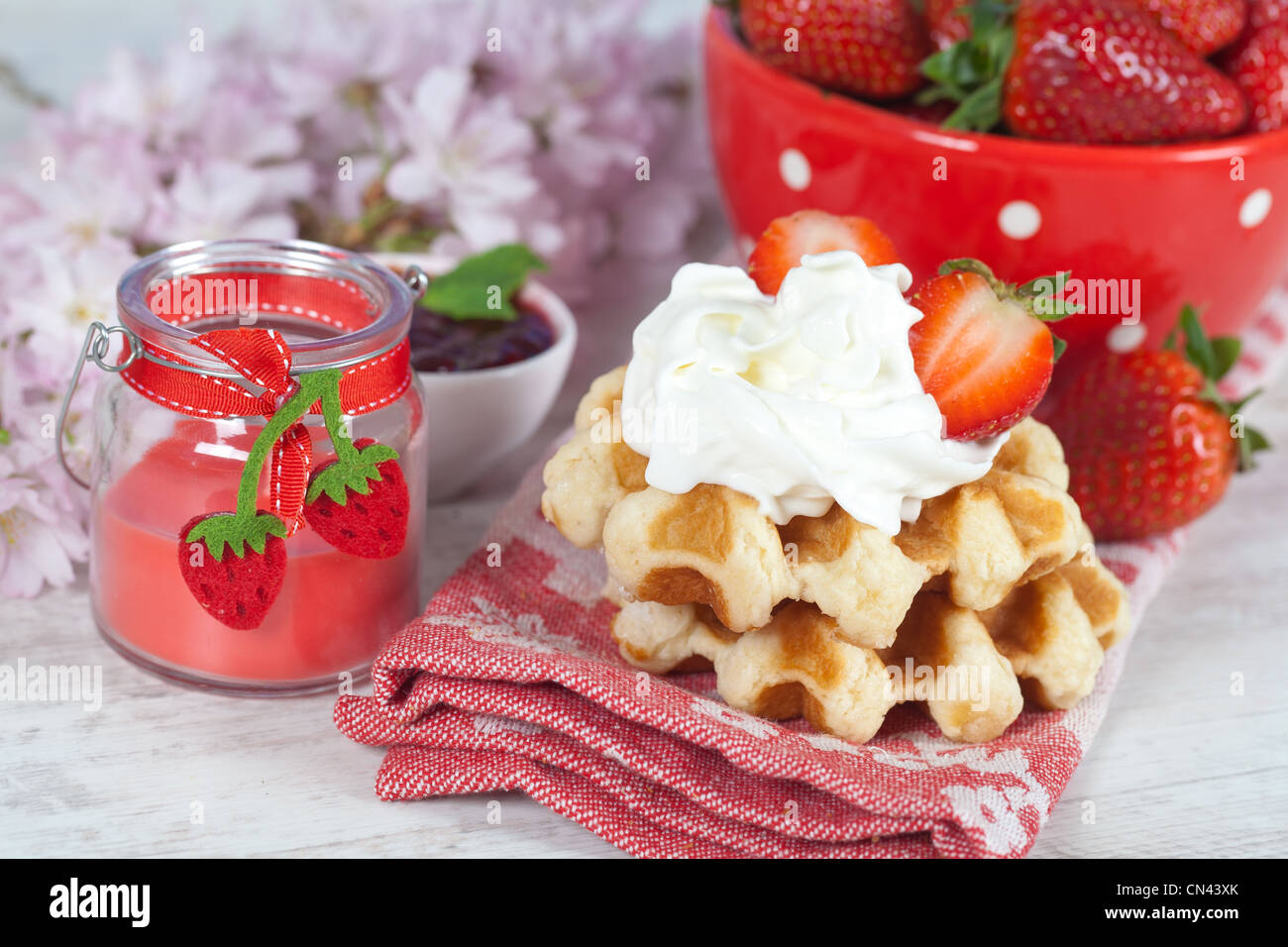 Delicious waffle with whipped cream and strawberries Stock Photo - Alamy