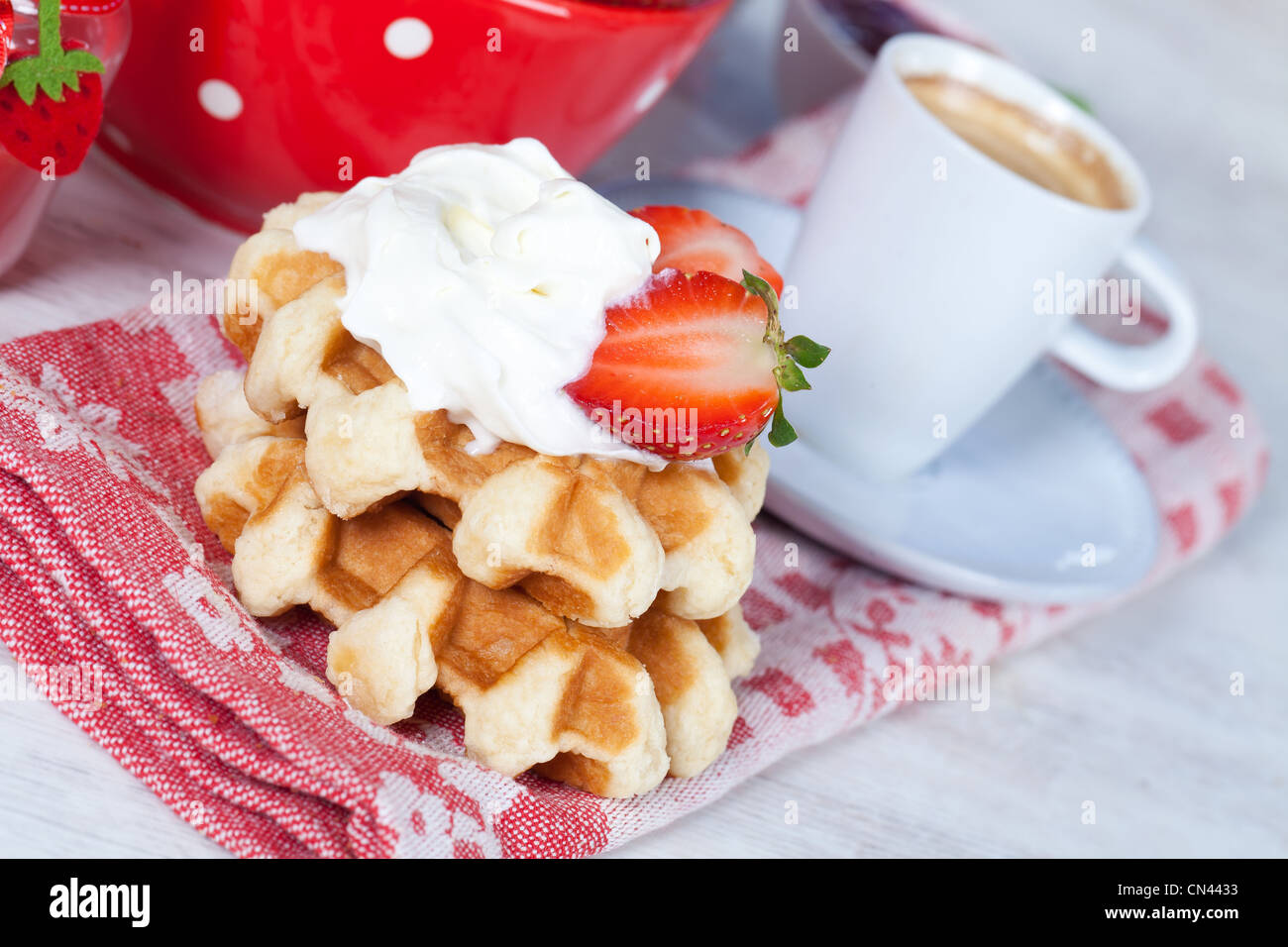 Delicious waffle with whipped cream and strawberries Stock Photo - Alamy