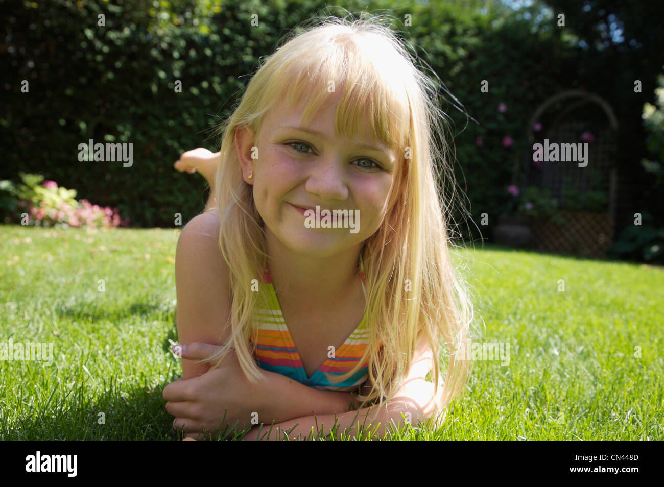 Girl Lying on Grass Stock Photo - Alamy