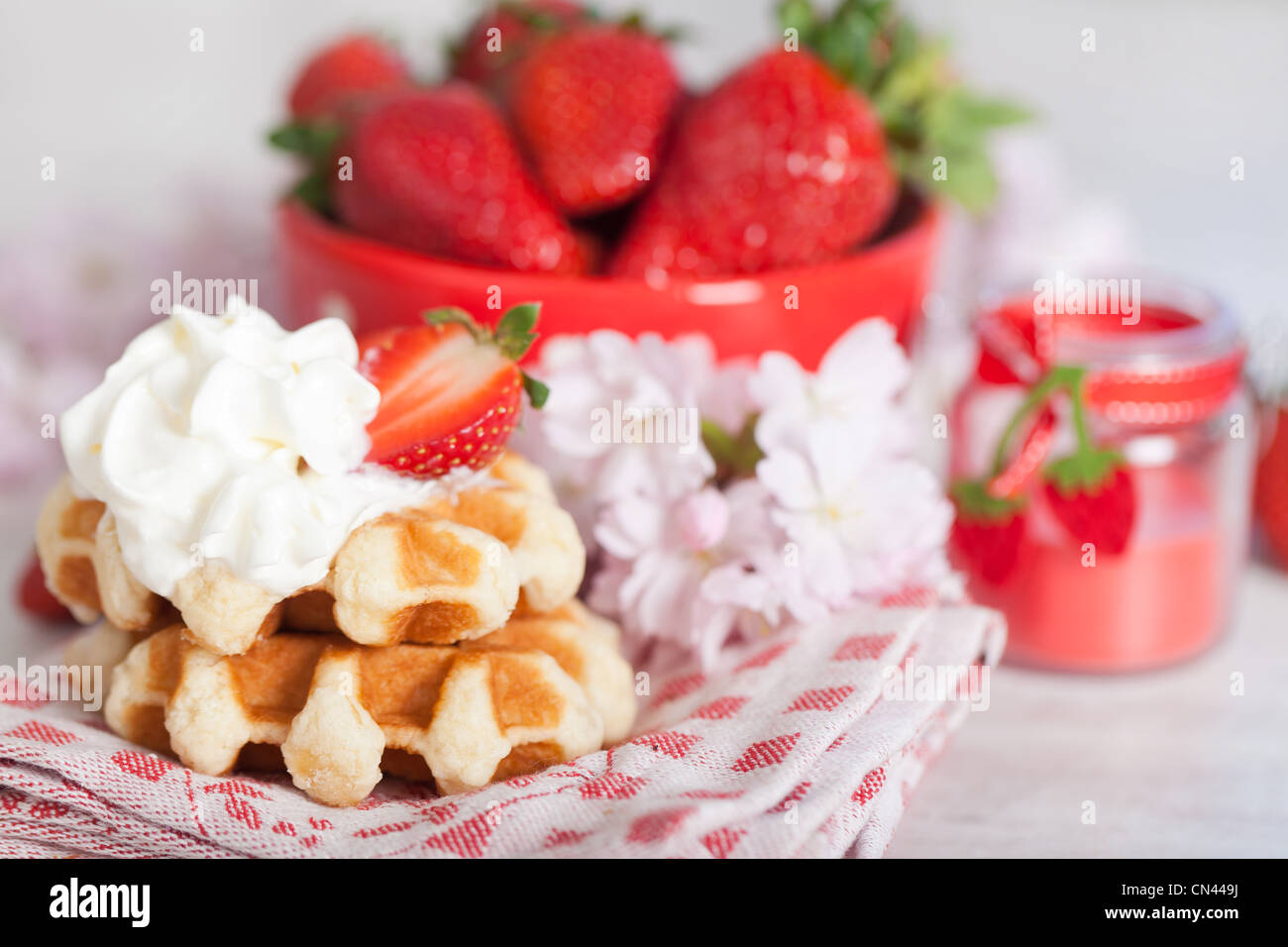 Delicious waffle with whipped cream and strawberries Stock Photo - Alamy