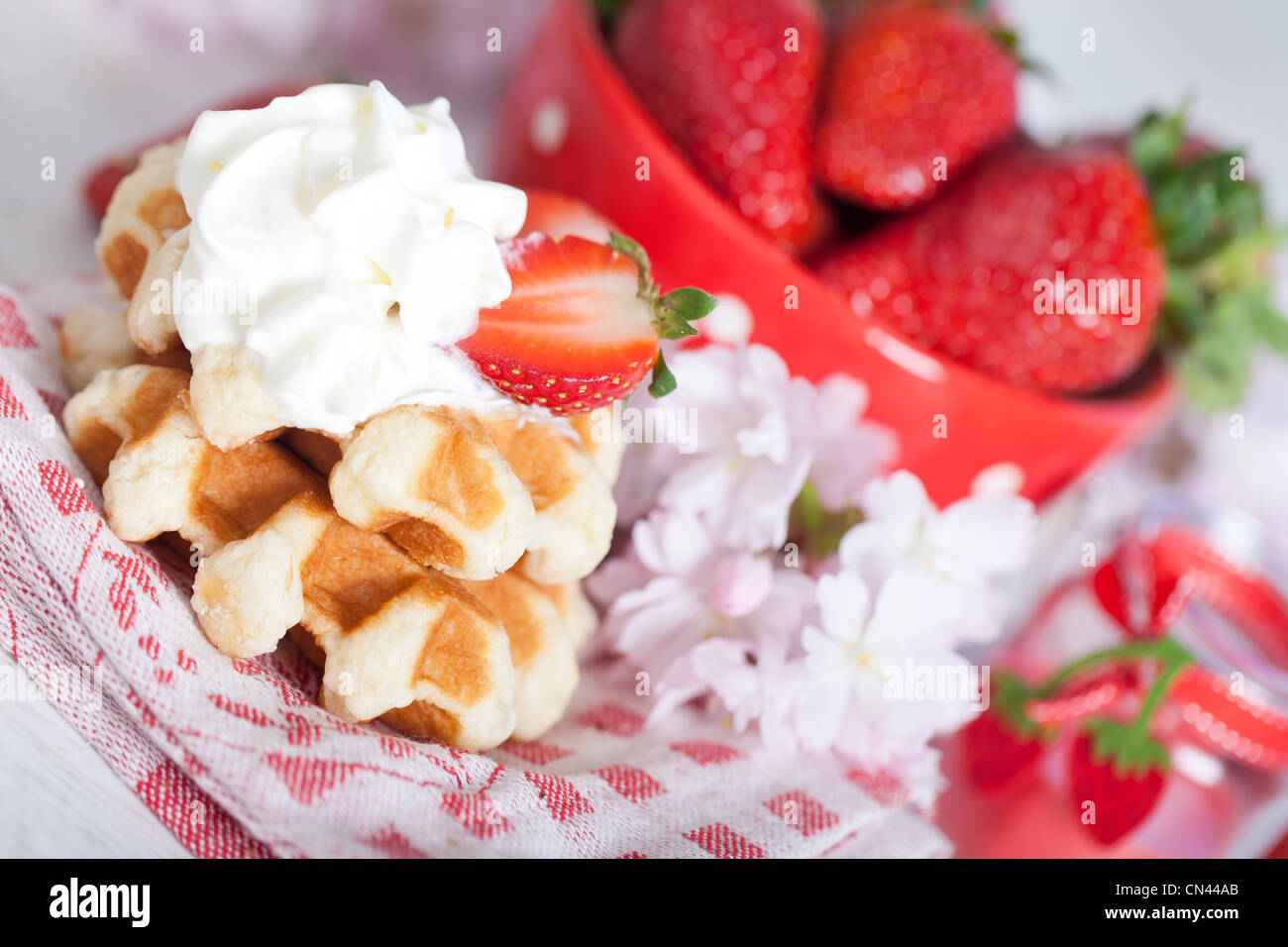 Delicious waffle with whipped cream and strawberries Stock Photo - Alamy