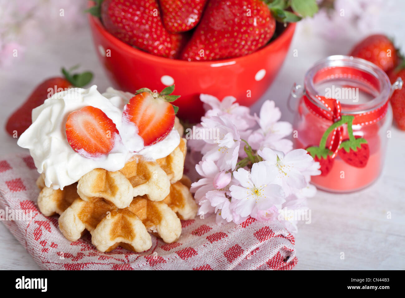 Delicious waffle with whipped cream and strawberries Stock Photo - Alamy
