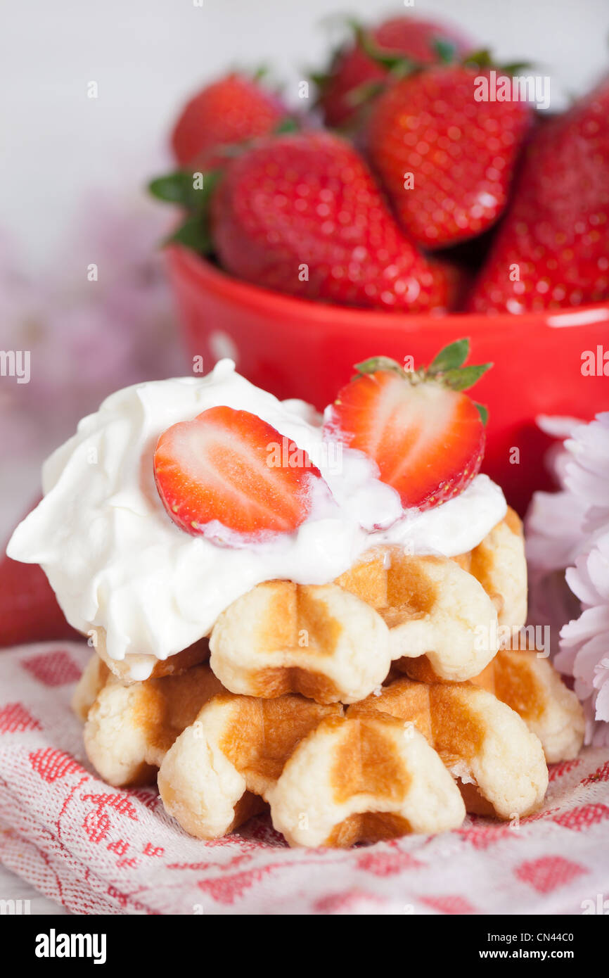 Delicious waffle with whipped cream and strawberries Stock Photo - Alamy