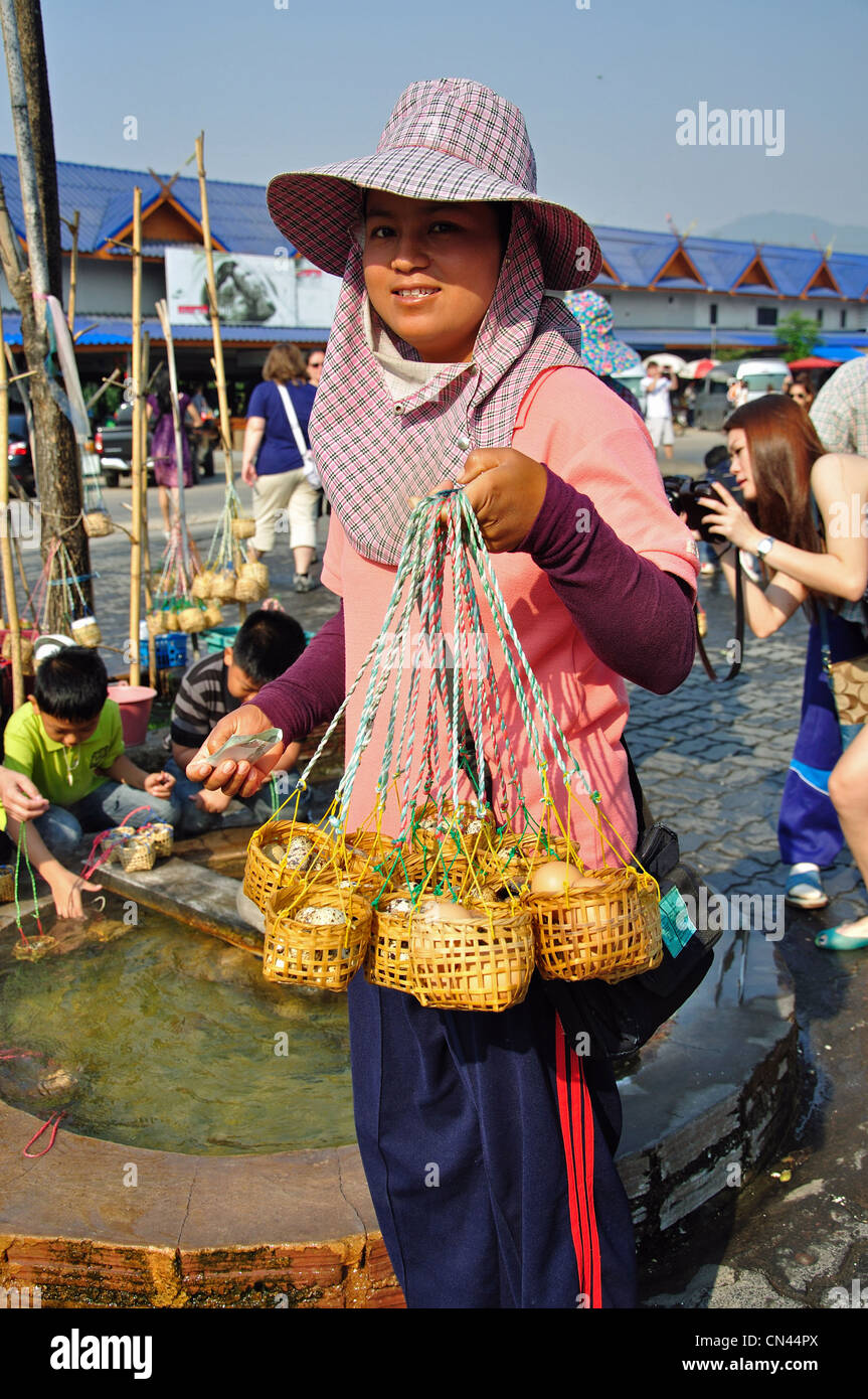 Woman selling bird's eggs in baskets at Wieng Pa Pao hot spring at