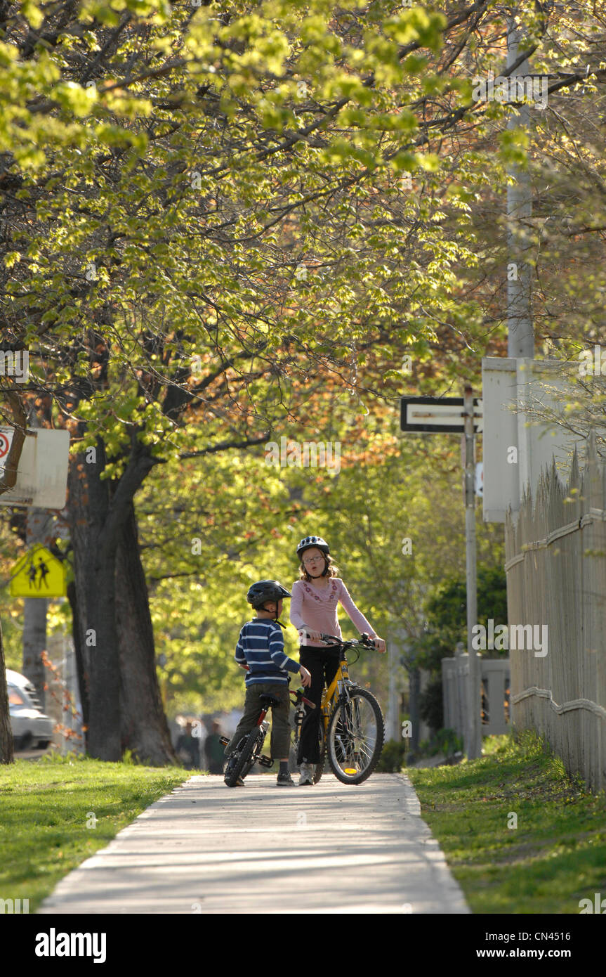Brother and Sister Stopped with Bicycles on Sidewalk, Toronto, Ontario Stock Photo Alamy