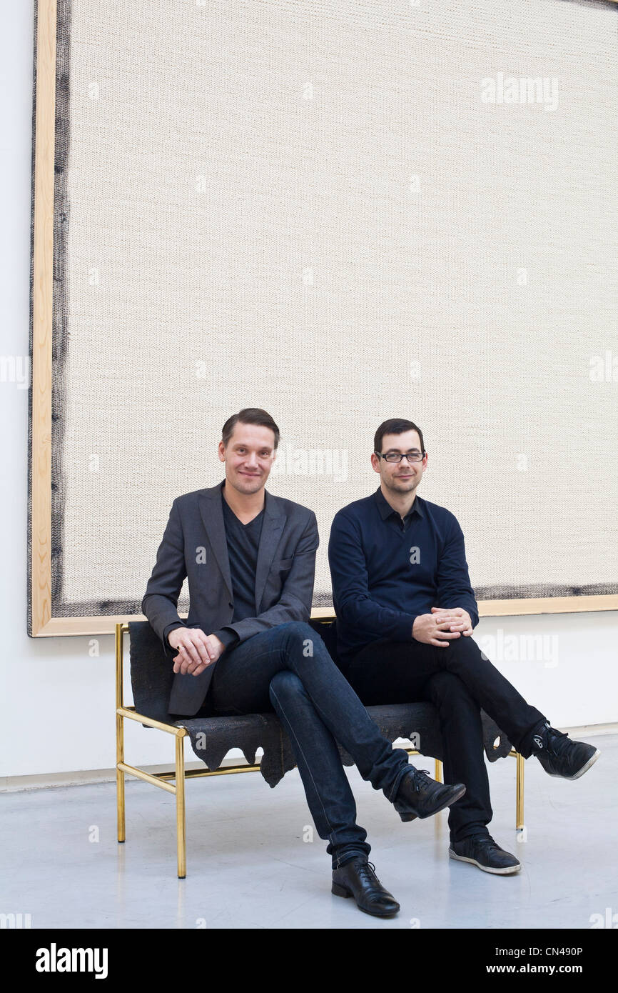 United Kingdom, London, Lambeth, David Gill gallery, designers Patrick Fredrikson and Ian Stallard next to an artwork by artist Stock Photo