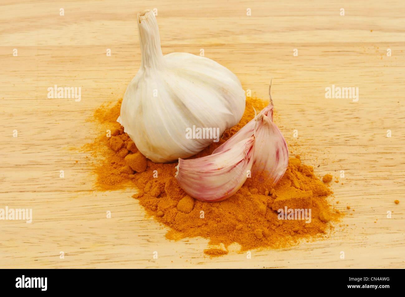 Garlic and tumeric spice on a wooden board Stock Photo