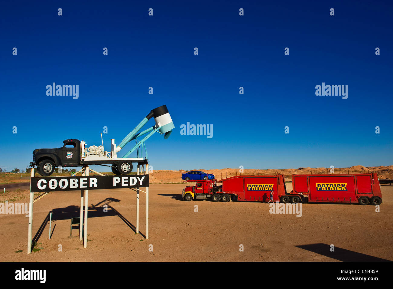 Australia, South Australia, Coober Pedy, a blower, a truck for opal mining symbol of the entrance of Coober Pedy and a road Stock Photo