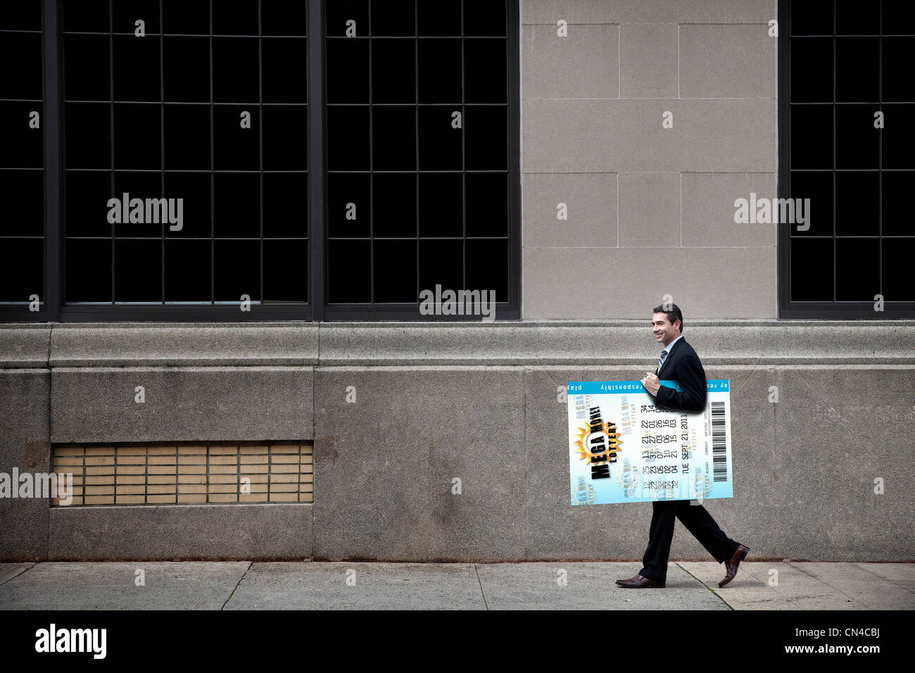 Businessman carrying oversized lottery ticket Stock Photo