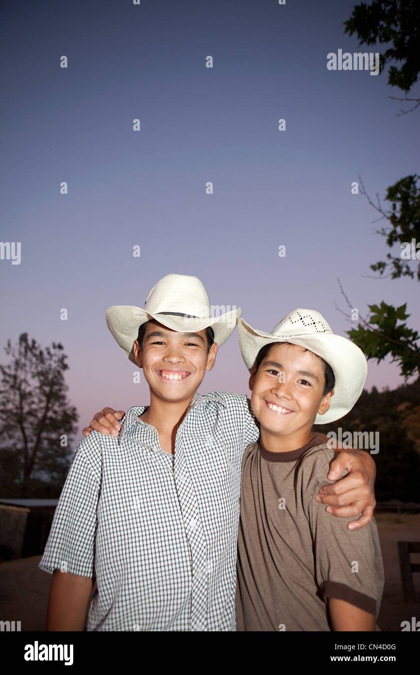 Brothers wearing cowboy hats and smiling, portrait Stock Photo