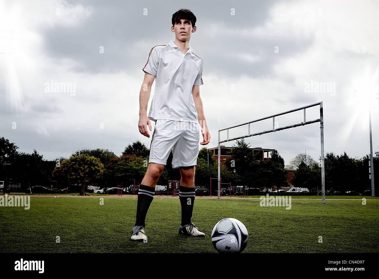Soccer player standing on pitch Stock Photo