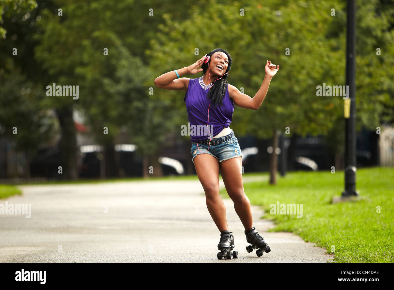 Young woman rollerskating listening music hi-res stock photography and  images - Alamy