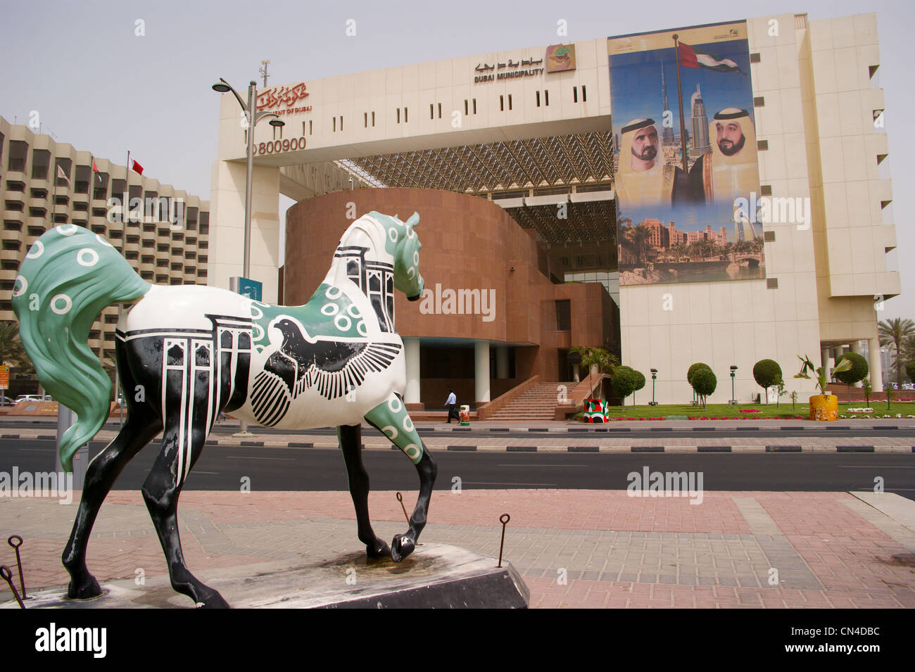 Dubai Municipality government offices, Dubai Creek, United Arab Emirates with equine sculpture Stock Photo
