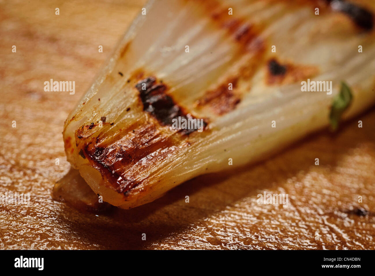 fried onion on wooden cutting board Stock Photo