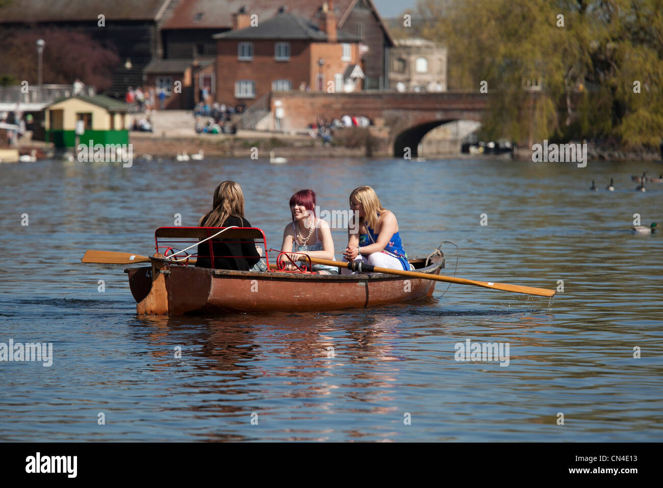 Three girls rowing down the river Avon in Stratford upon Avon