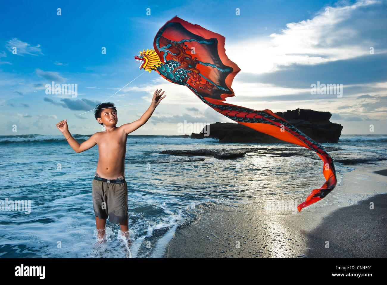 Indonesia, Bali Island, Purah Tanah Lot temple, kid playing with a kite Stock Photo