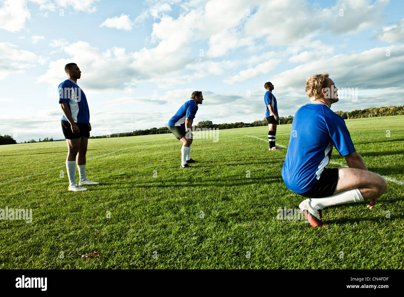 Soccer players standing on pitch Stock Photo Alamy