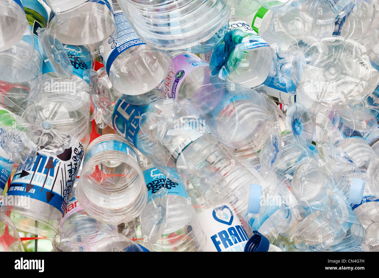 Discarded plastic bottles attached to a wire mesh fence highlight the need for more recycling of precious materials Stock Photo