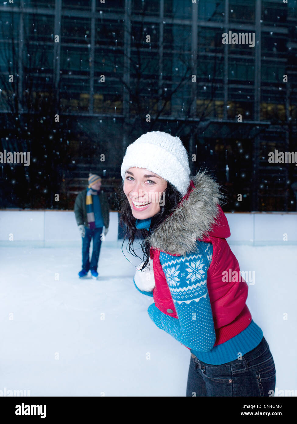 Woman skating on an ice rink in the snow Stock Photo