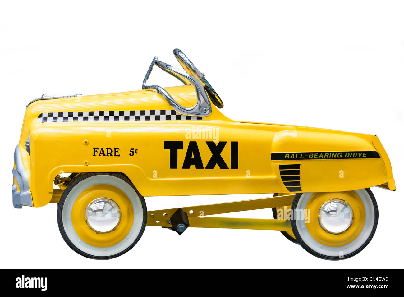 Kid's size small version of a vintage Yellow New York Taxi Cab. A push bike pedal car. Cut out isolated on white background. Stock Photo