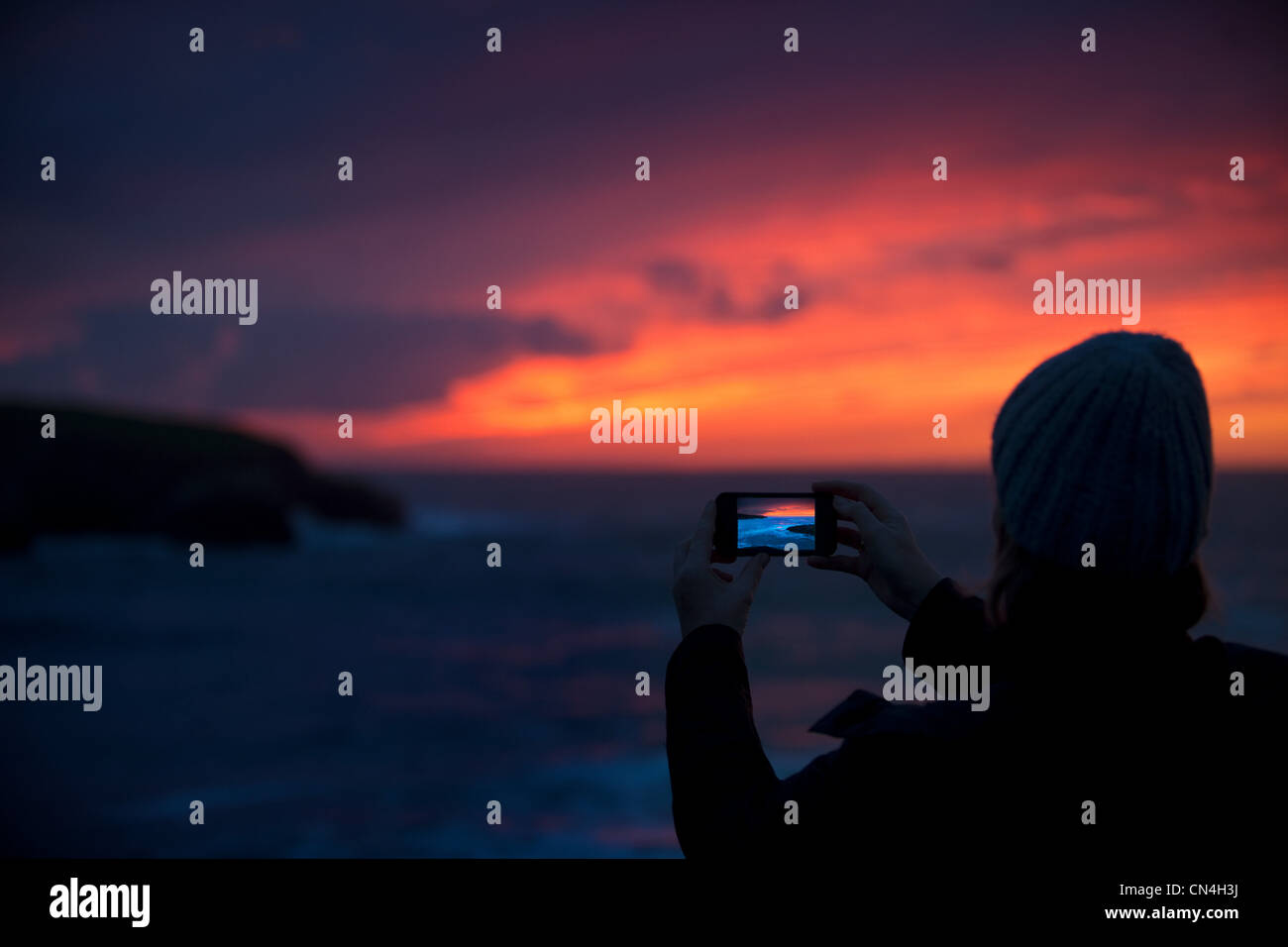 Person photographing sunrise Stock Photo