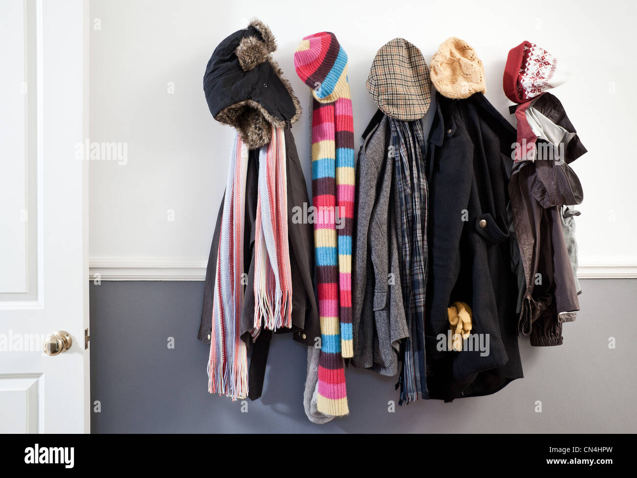 Coats and hats hanging on wall in hallway Stock Photo - Alamy