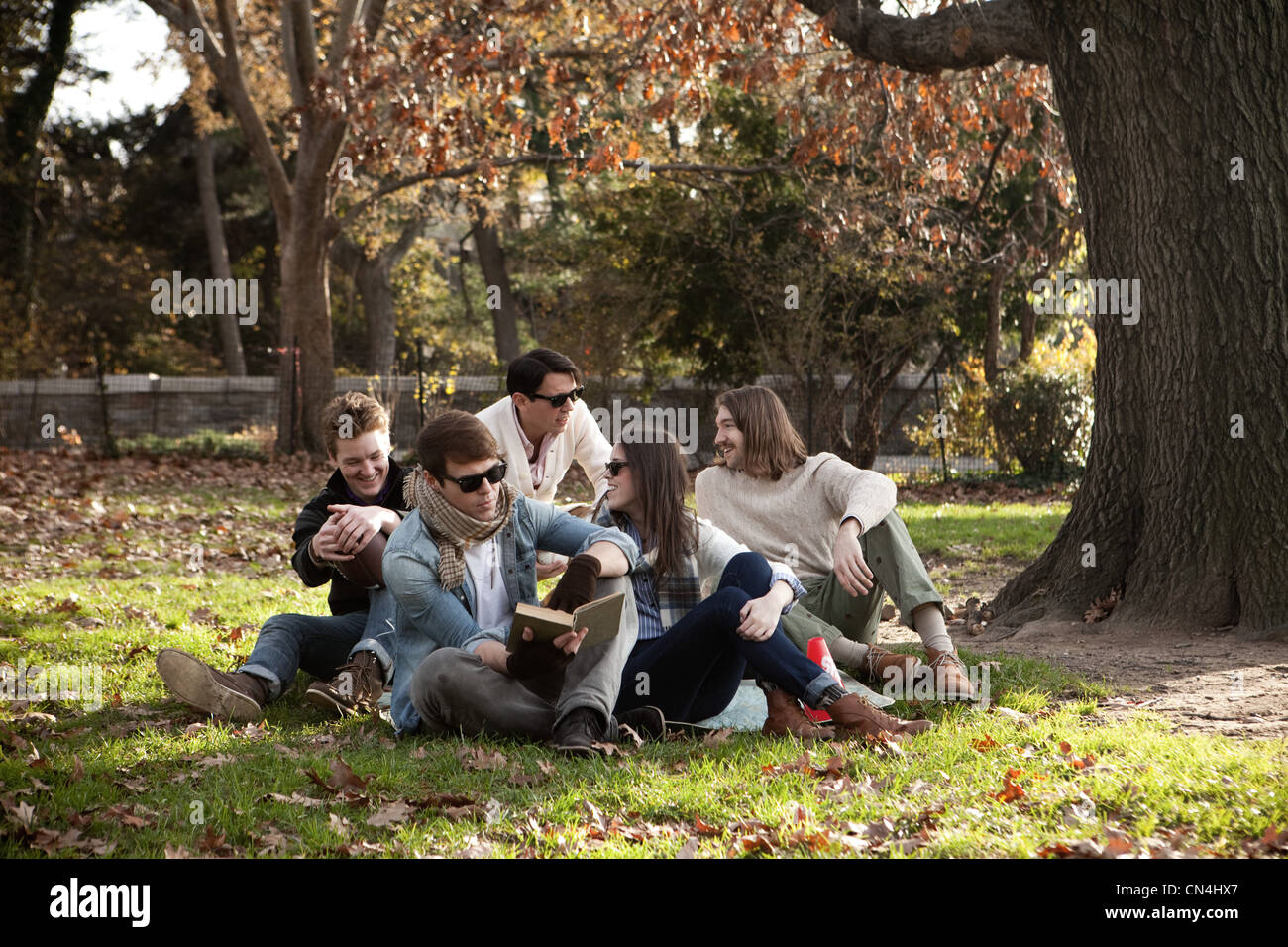 College friends relaxing in park Stock Photo